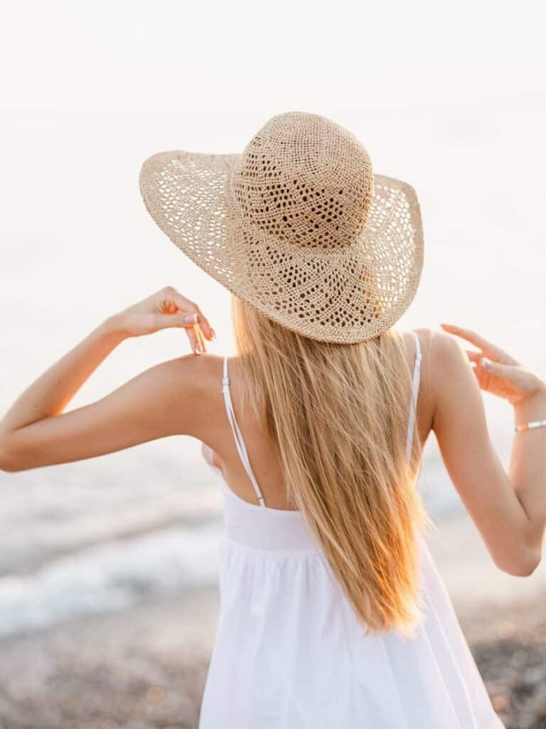 woman in a sun hat and white sundress | what to wear to Mombasa coast