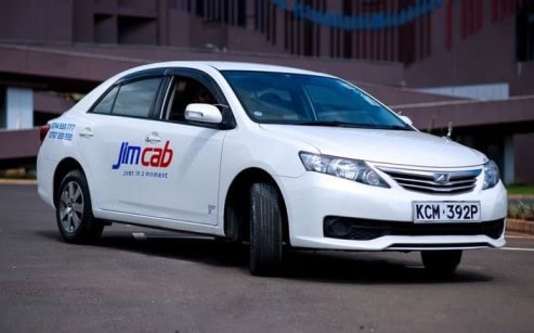 A white Jim Cab taxi parked at Two rivers mall in Nairobi